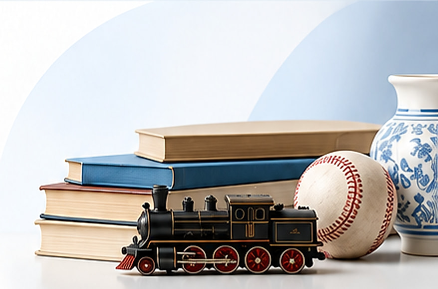 A stack of books, a model train, a baseball and blue and white porcelain vases